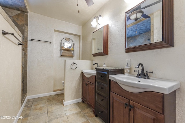 59 Arroyo Pkwy, Ormond Beach, FL 32174 - bathroom featuring two vanities, a textured wall, a walk in shower, and a ceiling fan