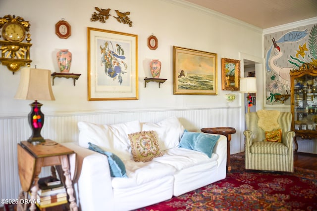 living room with crown molding and wainscoting