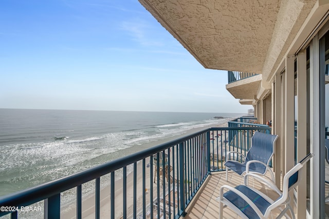 balcony with a view of the beach and a water view