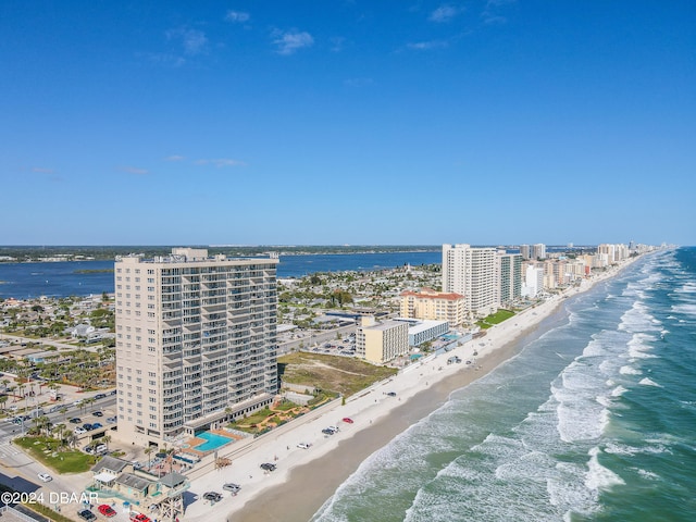 drone / aerial view featuring a view of the beach and a water view