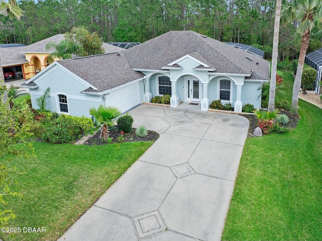 ranch-style home with a shingled roof, a front lawn, concrete driveway, stucco siding, and a garage