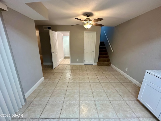 unfurnished room featuring ceiling fan and light tile patterned floors