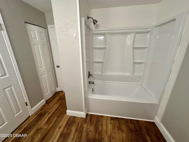 bathroom with shower / bathtub combination and wood-type flooring