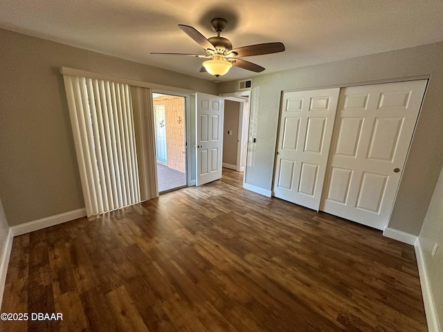 unfurnished bedroom featuring ceiling fan, dark hardwood / wood-style floors, and a closet