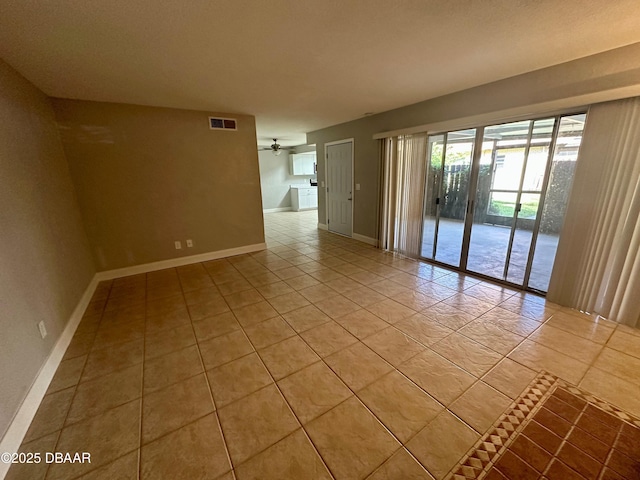 unfurnished room featuring ceiling fan and light tile patterned floors