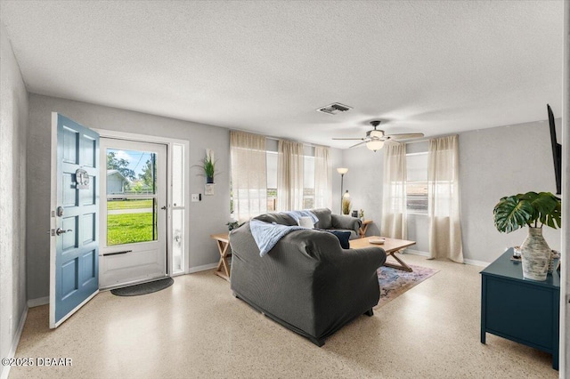 211 Fox Pl, Port Orange, FL 32127 - living room featuring plenty of natural light, a textured ceiling, speckle patterned floor, and a ceiling fan