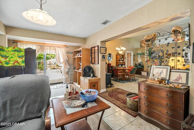 living room featuring visible vents, tile patterned floors, and a chandelier