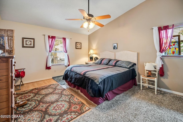 bedroom with wood finished floors, baseboards, a ceiling fan, and vaulted ceiling