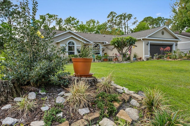 view of front facade with a front yard, roof with shingles, stucco siding, and an attached garage