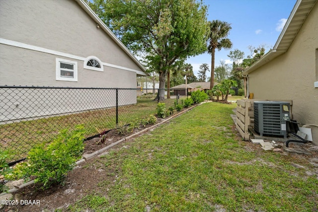 view of yard featuring central air condition unit and fence
