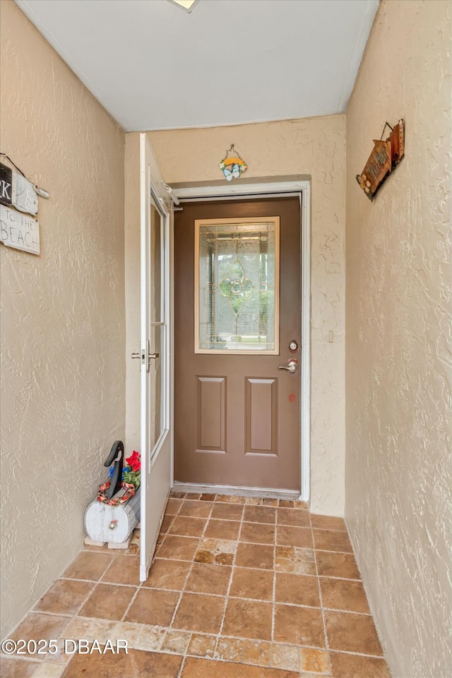 property entrance featuring stucco siding