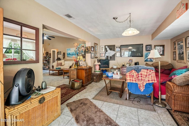 living room featuring visible vents and a ceiling fan