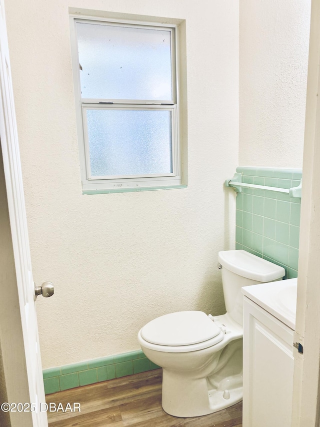 bathroom with hardwood / wood-style floors, vanity, and toilet