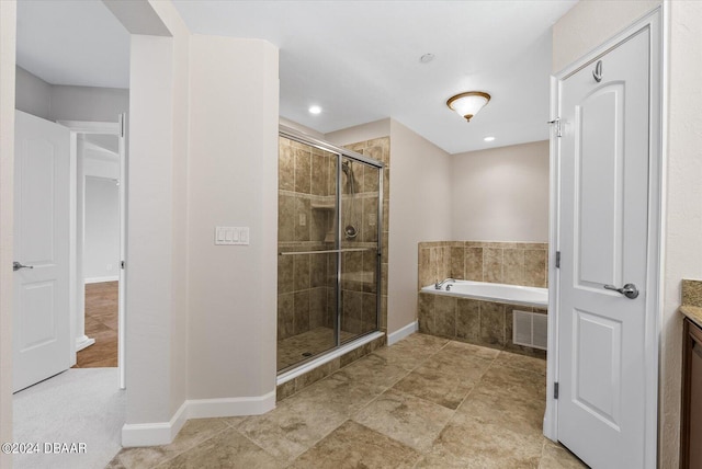 bathroom with vanity and shower with separate bathtub