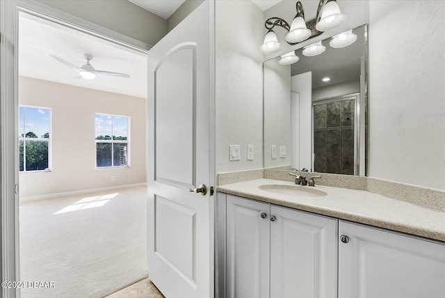 bathroom featuring vanity, ceiling fan, and a shower