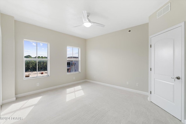 unfurnished room with light carpet and ceiling fan