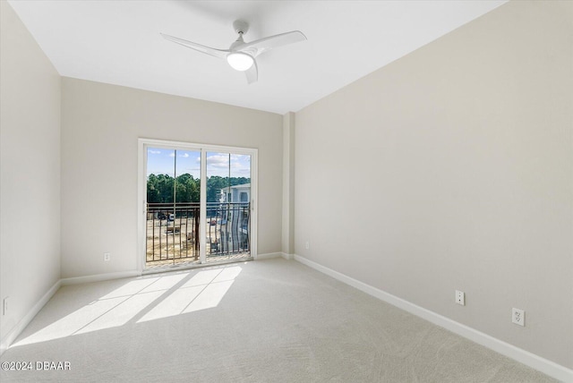 carpeted spare room featuring ceiling fan