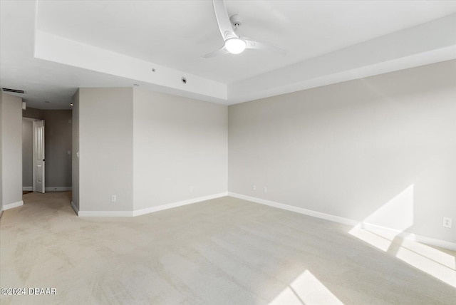 spare room featuring light colored carpet and ceiling fan