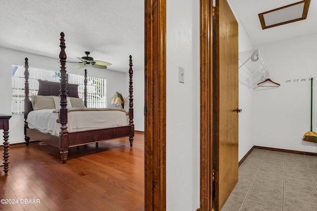 bedroom with hardwood / wood-style floors and a textured ceiling