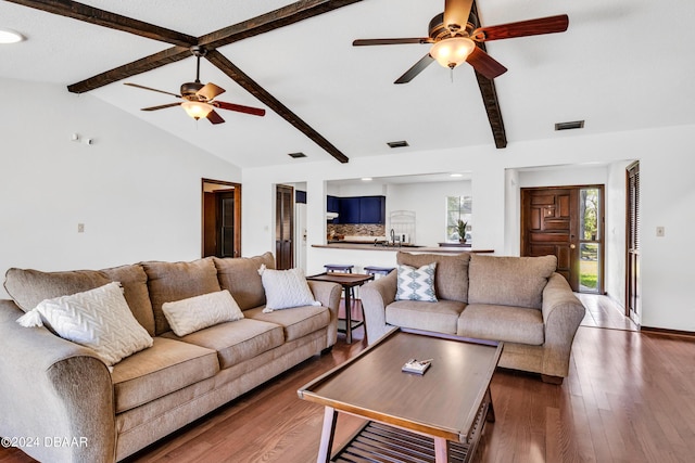 living room with dark hardwood / wood-style flooring, vaulted ceiling with beams, and ceiling fan