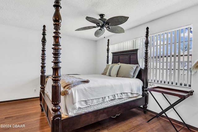 bedroom featuring hardwood / wood-style flooring, ceiling fan, and a textured ceiling