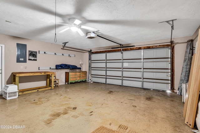 garage with ceiling fan, a garage door opener, and electric panel