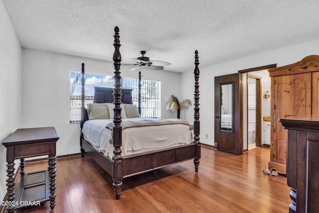 bedroom featuring wood-type flooring and a textured ceiling