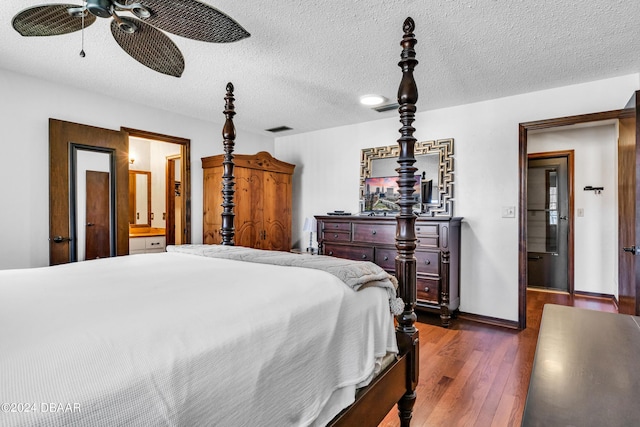 bedroom with ceiling fan, ensuite bathroom, dark hardwood / wood-style floors, and a textured ceiling