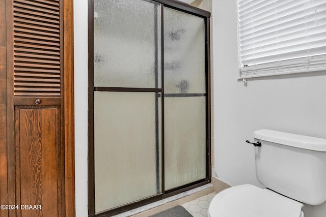 bathroom with walk in shower and toilet