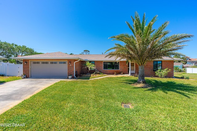 16 W Tipperary Ln, Ormond Beach, FL 32176 - single story home featuring a garage, driveway, fence, a front yard, and brick siding