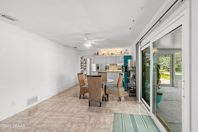16 W Tipperary Ln, Ormond Beach, FL 32176 - dining room with light tile patterned floors, visible vents, and ceiling fan