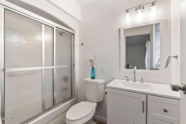 full bathroom with vanity, enclosed tub / shower combo, and toilet