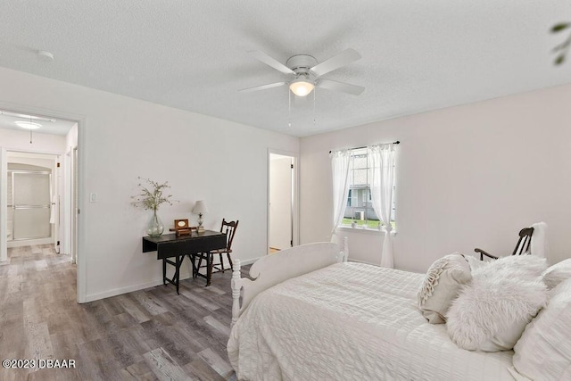 bedroom featuring ceiling fan, hardwood / wood-style floors, and a textured ceiling