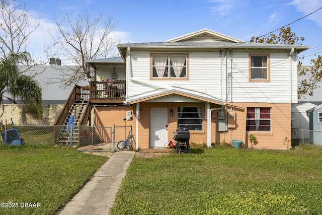 view of front of house featuring a front yard and a wooden deck