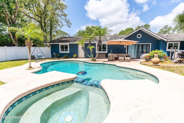 view of pool with fence, a patio, an outdoor living space, and a pool with connected hot tub