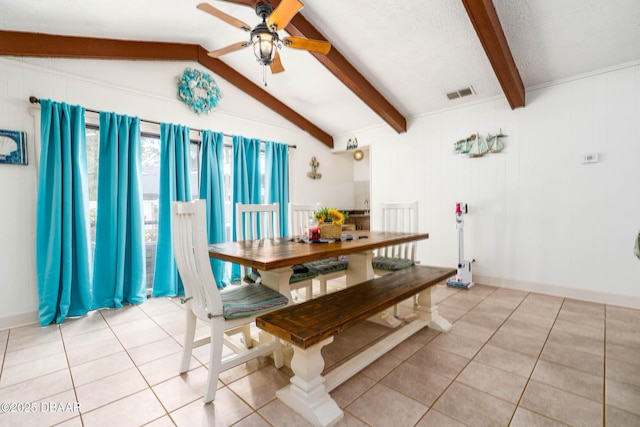 dining room with light tile patterned floors, visible vents, a ceiling fan, and vaulted ceiling with beams