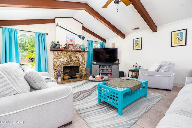 tiled living area with a fireplace, visible vents, ceiling fan, and vaulted ceiling with beams
