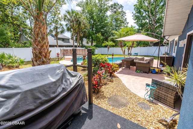 exterior space featuring an outdoor hangout area, area for grilling, a fenced in pool, and a fenced backyard