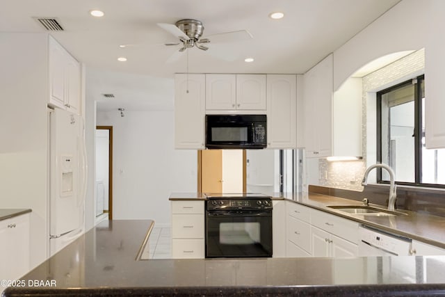 kitchen featuring a sink, visible vents, white cabinetry, backsplash, and black appliances