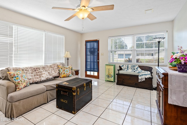 tiled living room featuring ceiling fan