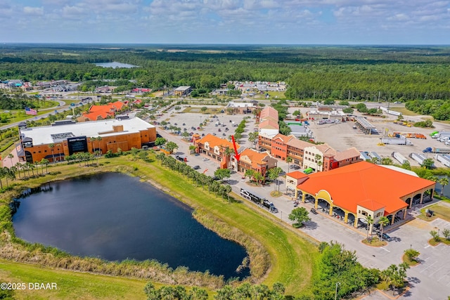 drone / aerial view featuring a water view and a forest view