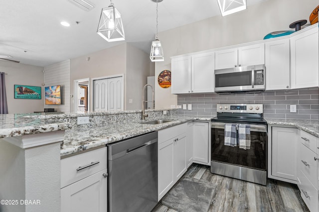 kitchen with white cabinetry, tasteful backsplash, a sink, visible vents, and stainless steel appliances