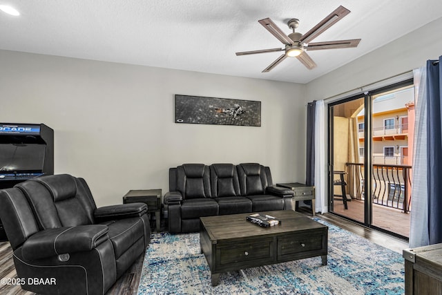 living room featuring wood finished floors and a ceiling fan