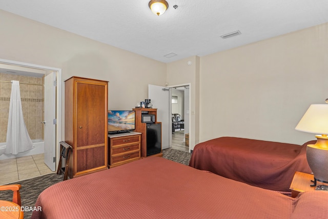 bedroom with tile patterned flooring and visible vents
