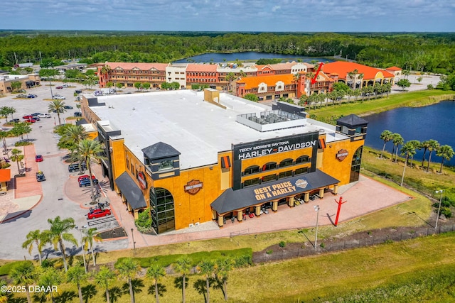 bird's eye view featuring a wooded view and a water view