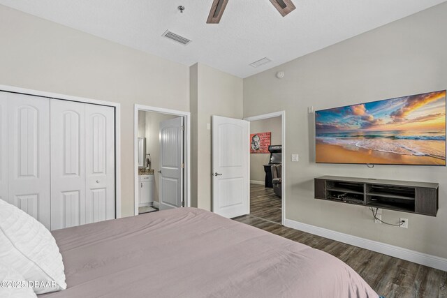 bedroom with a closet, a ceiling fan, visible vents, baseboards, and wood finished floors