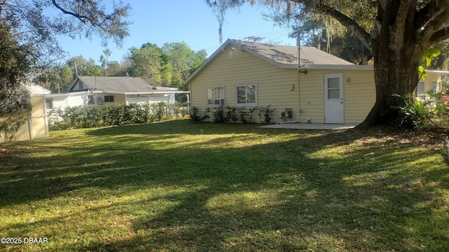 back of property with a patio and a yard