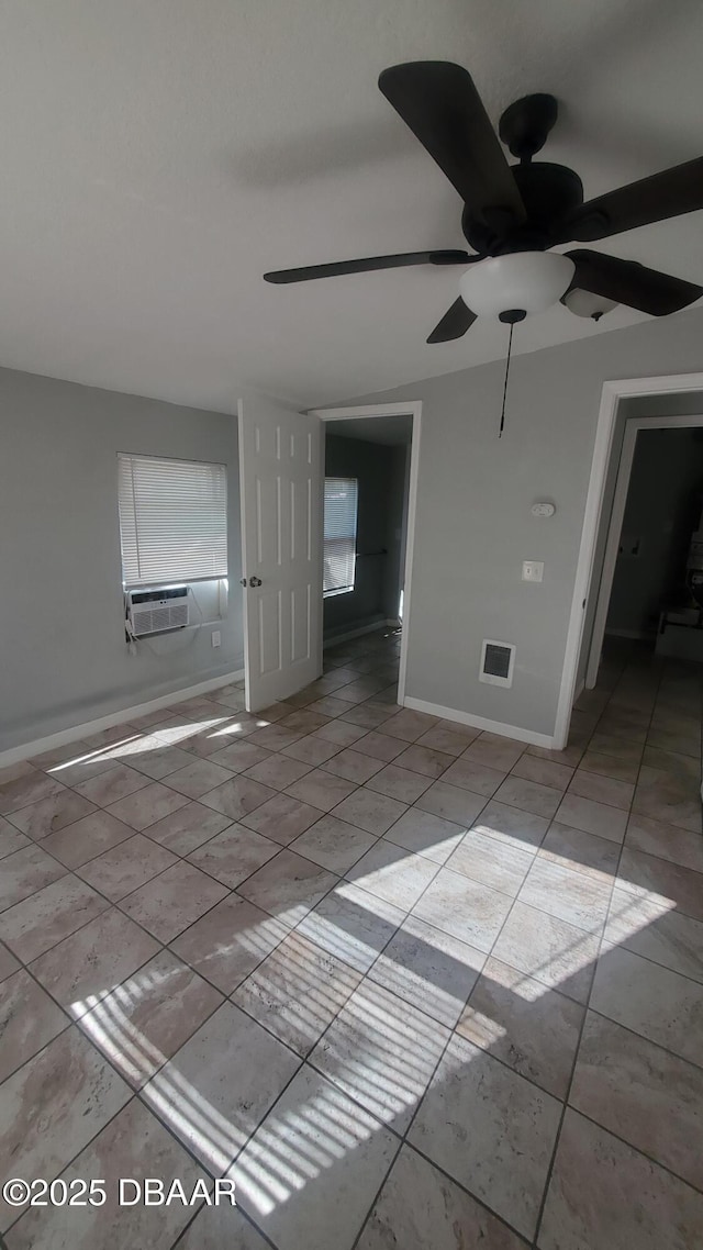 spare room with visible vents, baseboards, ceiling fan, cooling unit, and light tile patterned flooring