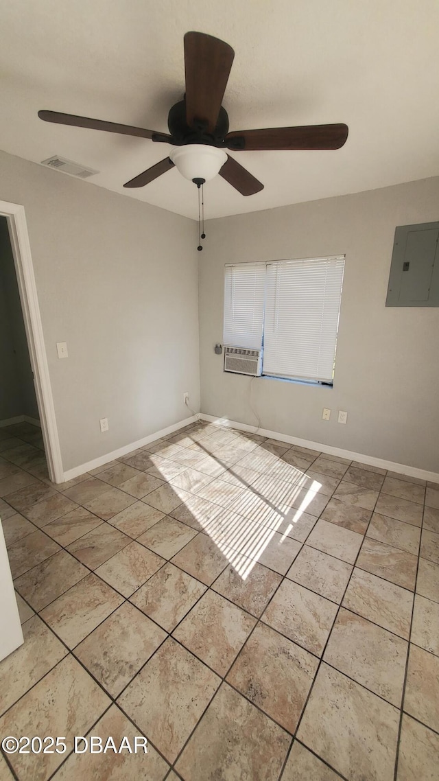 spare room featuring electric panel, light tile patterned floors, baseboards, and a ceiling fan