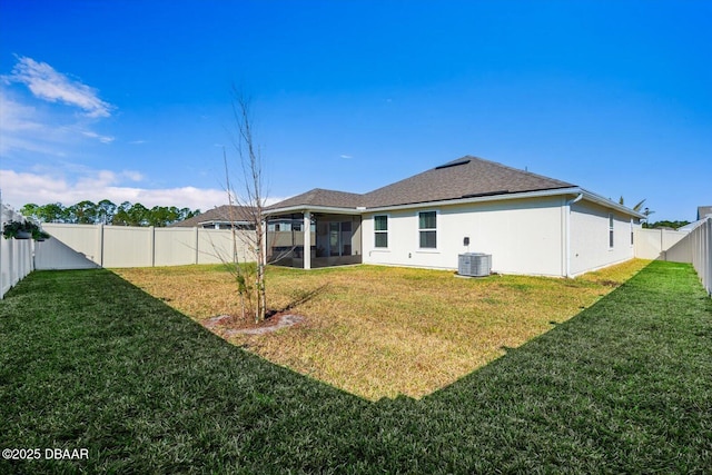 back of property with a yard, central AC, and a sunroom